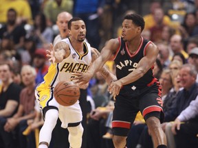 Raptors guard Kyle Lowry (right) makes a pass against Pacers guard George Hill (left) during the first quarter in Game 4 of the first round of the NBA playoffs in Indianapolis on Saturday, April 23, 2016. (Brian Spurlock/USA TODAY Sports)