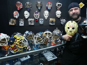 Jimmy Mac poses with a selection from his huge collection of goalie masks inside of Dee's Collectible on Henderson Highway in Winnipeg on Sat., April 23, 2016. (Kevin King/Winnipeg Sun/Postmedia Network)