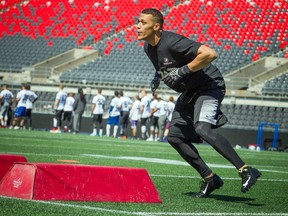 Jonathan Jones pushes through a drill during the Redblacks open tryouts at TD Place in Ottawa on Saturday, April 23, 2016. (Ashley Fraser/Postmedia Network)