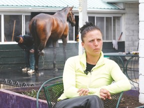 Erika Smilovsky ponders her situation at Woodbine Racetrack after being forced to abandon her job as an apprentice jockey. (Michael Peake, Toronto Sun)