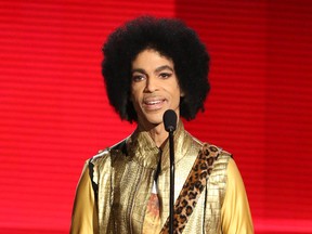 In this Nov. 22, 2015 file photo, Prince presents the award for favorite album - soul/R&B at the American Music Awards in Los Angeles.  (Photo by Matt Sayles/Invision/AP, File)