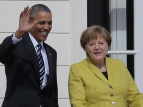 German Chancellor Angela Merkel, right, welcomes U.S. President Barack Obama at Herrenhausen Palace in Hannover, northern Germany, Sunday, April 24, 2016. Obama is on a two-day official visit to Germany. (AP Photo/Markus Schreiber)