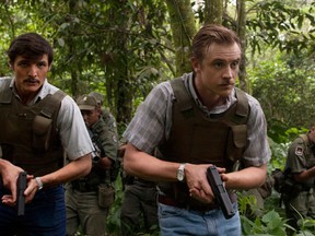 This undated production photo provided by Netflix, shows actors Pedro Pascal, left, as Javier Pena, and Boyd Holbrook as Steve Murphy in the Netflix Original Series "Narcos."  The series that debuts on Aug. 28, 2015, is based on the account of Murphy and Pena, now-retired Drug Enforcement Administration agents who were assigned to bring the drug lord down. (Daniel Daza/Netflix via AP)