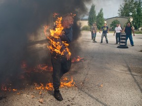 Free Press photographer Craig Glover was named Photojournalist of the Year at the Ontario Newspaper Association awards Saturday night for work including this arresting image of native protester Pierre George being engulfed in flames during a dispute between members of the Kettle and Stony Point First Nations at the entrance to the former army camp in Ipperwash on Sept. 30, 2015. The shot also took Spot News Photography honours. (CRAIG GLOVER, The London Free Press)