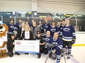 Belleville Police Association teams makes a $800 donation to the Clark family during the Corey Clark Classic.