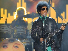 FILE - In this May 19, 2013, file photo, Prince performs at the Billboard Music Awards at the MGM Grand Garden Arena in Las Vegas. Tickets for what turned out to be Prince's last concert, in Atlanta, went on sale just eight days before he was scheduled to play and sold out almost instantly. (Photo by Chris Pizzello/Invision/AP, File)