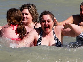Caroline Bekkers reacts after she and others waded into crisp Lake Huron waters for the Canadian Cancer Society's inaugural Daffodil Dip event Saturday. About 30 people took part at the Sarnia Riding Club, organizers said. (Tyler Kula/Sarnia Observer/Postmedia Network)