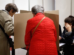 People prepare ballots at a polling station in Belgrade, Serbia, Sunday, April 24, 2016. Serbs are voting in a snap parliamentary election that will test Prime Minister Aleksandar Vucic’s proclaimed bid to lead the Balkan country toward European Union integration. (AP Photo/Darko Vojinovic)