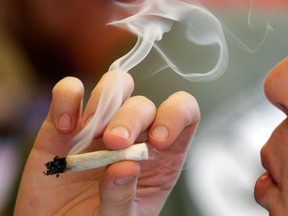 FILE - Man smoking marijuana.(AP Photo/Elaine Thompson)