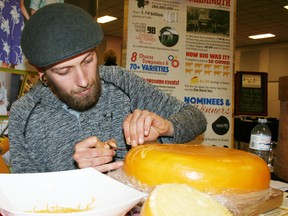 Artist Thomas Cushing of Kitchener carved a scene into a large wheel of gouda during the Dairy Capital Cheese Fest at Oxford Auditorium on Saturday, April 23, where turophiles - a fancy term for cheese lovers - flocked to indulge their passion for fromage. JOHN TAPLEY/SENTINEL-REVIEW