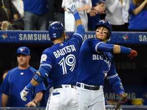 Toronto Blue Jays right fielder Jose Bautista is greeted by shortstop Troy Tulowitzki after hitting a two run home run against Oakland Athletics at Rogers Centre. (Dan Hamilton/USA TODAY Sports)