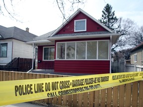 Police tape surrounds a house at 560 Redwood Ave. in Winnipeg, Man. Sunday, April 24, 2016 following a homicide police began investigating on the morning of Saturday, April 23. A woman in her thirties is deceased. (Brian Donogh/Winnipeg Sun/Postmedia Network)