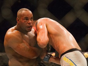 UFC Light Heavyweight champ Daniel Cormier and challenger Alexander Gustasson battle in a mixed material arts bout at MMA UFC 192, Saturday, Oct. 3, 2015 in Houston. (AP Photo/Juan DeLeon)