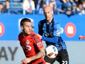 Toronto FC forward Sebastian Giovinco plays the ball in front of Impact defender Laurent Ciman on Saturday. Giovinco had two goals in the Reds’ impressive victory. (USA TODAY)