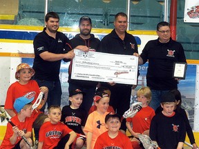Wallaceburg Thrashers president Steve Lilley, from left, Wallaceburg Minor Lacrosse president Rory Smith, Wallaceburg Red Devils president Gord Lilley, and Wallaceburg Minor Lacrosse past chairman and fundraising chairman Chris Dawson celebrate receiving an Ontario Trillium Fund grant for $266,800 on Sunday at Wallaceburg Memorial Arena. (DAVID GOUGH/Postmedia Network)