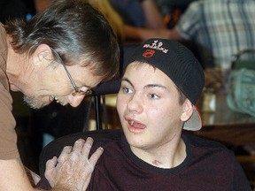 Brayden Fields talks with a friend, during a fundraiser to help with his rehabilitation costs, held at the CBD Club on Saturday.