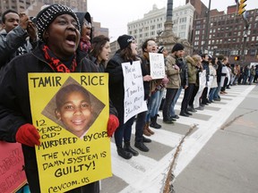 In this Nov. 25, 2014, file photo, demonstrators block Public Square in Cleveland, during a protest over the police shooting of Tamir Rice. The city of Cleveland has reached a settlement April 25, 2016, in a lawsuit over the death of Rice, a black boy shot by a white police officer while playing with a pellet gun. (AP Photo/Tony Dejak, File)