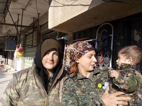 Shaelynn Jabs (left) with her friend from Poland that goes by her Kurdish name ‘Dastana’ were walking down a street in the town of Tel Tamer in northeastern Syria in their uniforms and were approached by a family to show them their child’s uniform. They wanted the duo to know how thankful they are for all the fighters that are helping Syrians.