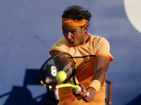 Rafael Nadal of Spain returns a ball to Kei Nishikori of Japan during Barcelona Open tennis tournament in Barcelona, Spain, April 24, 2016. (REUTERS/Albert Gea)