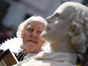 A man dressed as William Shakespeare poses next to a bust of the playwright during celebrations to mark the 400th anniversary of Shakespeare's death in the city of his birth, Stratford-Upon-Avon, Britain, April 23, 2016. REUTERS/Dylan Martinez