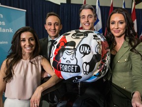 Erica Godfrey (from left), Noah Godfrey, Ben Mulroney and Jessica Mulroney pose with Gary Taxali's sculpture of a brain, which will be part of the Brain Project in Toronto, on Monday, April 25, 2016 at City Hall. (Craig Robertson/Toronto Sun)