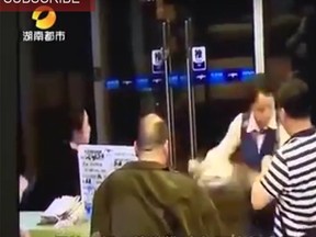 A video posted on YouTube by People's Daily shows airline passengers after they were caught on video slapping, verbally abusing and throwing food at ground staff  at an airport in the city of Changsha, China, over a delayed flight. (People's Daily/YouTube)
