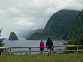 In this Feb. 6, 2016 photo, hikers overlook a bluff on the Kalaupapa Peninsula in Kalawao, Hawaii. (AP Photo/Marco Garcia)