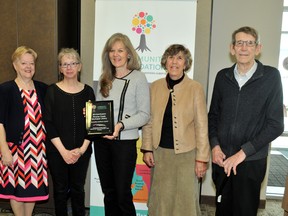 Community foundation grants committee member Lynne Sherwood presents a plaque to the representatives from the Pincher Creek Library on April 15 at the Community Foundation office in Lethbridge. Lifetouch photo/Submitted
