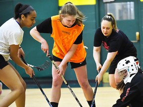 Belleville's Hannah Wilson (orange shirt) works on her floorball skills during a recent workout in Hamilton. Floorball experts say the sport is ideal for improving hockey skills. (Floorball Canada photo)