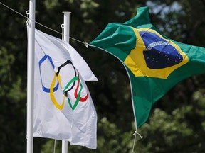 The Olympic and the Brazilian flag fly over the site of ancient Olympia during the Olympic flame lighting ceremony for the Rio 2016 Olympic Games in Greece on April 21, 2016. (REUTERS/Alkis Konstantinidis)