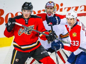Calgary Flames winger Micheal Ferland and Florida Panthers defenceman Willie Mitchell (33) fight for position in front of Florida goalie Al Montoya at Scotiabank Saddledome in Calgary. (Sergei Belski/USA TODAY Sports)