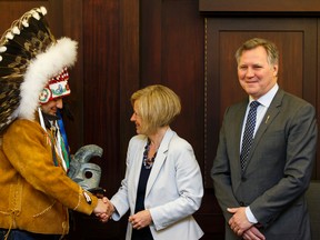 (Left to right) Deputy Grand Chief Isaac Laboucan-Avirom, Premier Rachel Notley and Indigenous Relations Minister Richard Feehan exchange gifts after signing a protocol agreement between the Government of Alberta and Treaty 8 First Nations at the Alberta Legislature in Edmonton, Alta., on Tuesday April 26, 2016. Photo by Ian Kucerak