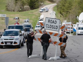 In this Friday, April 22, 2016 file photo, authorities set up road blocks at the intersection of Union Hill Road and Route 32 at the perimeter of a crime scene, in Pike County, Ohio. (AP Photo/John Minchillo, File)