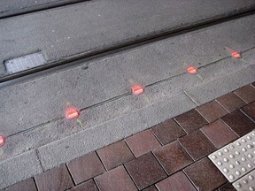 LED lights embedded into a walkway is pictured in this handout photo. While some cities debate a ban on walking and texting, a city in Germany has decided to just roll with the trend and install street lights on the ground, for those strolling into traffic with their heads down.
 Handout/Postmedia Network