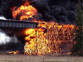 The Canadian National Railway bridge on the outskirts of Mayerthorpe goes up in flames. (Russell Claybrooks/supplied)