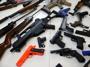 A file photo shows guns. Daudet had six handguns in his possession.