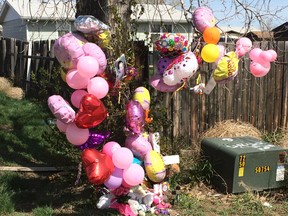 A memorial is placed in front of the house for 1-year-old Kenzley Olson on Friday, April 22, 2016, in Poplar, Mont. A federal investigator says a woman beat to death the girl on a Montana Indian reservation and threw the baby's body into a dumpster. (AP Photo/Richard Peterson)