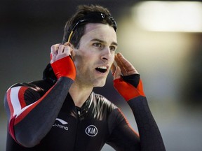 Denny Morrison looks at his time after competing in Calgary on March 17, 2016. (THE CANADIAN PRESS/Jeff McIntosh)