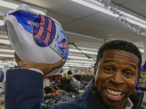 Pinball Clemons helps hand out turkeys at Honest Ed's during the 28th and last annual turkey giveaway on December 13, 2015. (Dave Thomas/Toronto Sun)