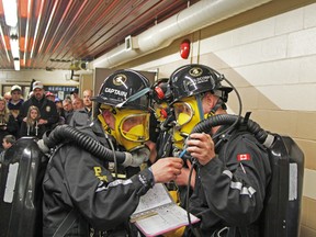 File photo shows Timmins mine rescuers checking their oxygen levels as they prepare to take part in a mine rescue scenario during a mine rescue competition event held in Timmins in May 2013.
