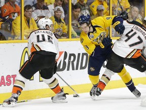 Ducks defenceman Hampus Lindholm (47) checks Predators centre Filip Forsberg (centre) as Ducks defenceman Sami Vatanen (45) controls the puck during Game 6 of their NHL playoff series in Nashville on Monday, April 25, 2016. The Ducks and Predators play Game 7 in Anaheim on Wednesday. (Mark Humphrey/AP Photo)