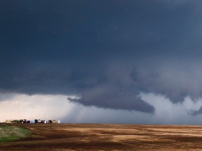 Storm clouds hang in the sky near Wellington, Kan., Tuesday, April 26, 2016. Thunderstorms bearing hail as big as grapefruit and winds approaching hurricane strength lashed portions of the Great Plains on Tuesday. (Travis Heying/The Wichita Eagle via AP)