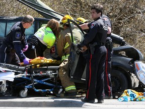 Emergency services respond to a single-vehicle collision at the intersection of Montreal Street and Weller Avenue at approximately 12:15 p.m. in Kingston, Ont. on Wednesday April 27, 2016. Steph Crosier/Kingston Whig-Standard/Postmedia Network