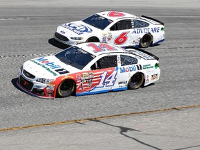 Sprint Cup Series driver Tony Stewart (14) races Trevor Bayne (6) during the Toyota Owners 400 at Richmond International Raceway. (Amber Searls/USA TODAY Sports)