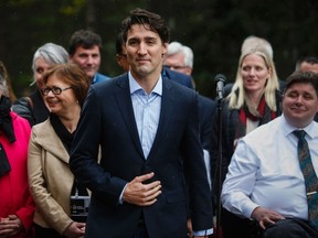 Prime Minister Justin Trudeau speaks to the media with his cabinet at a Liberal Party cabinet retreat in Kananaskis, Alta., Sunday, April 24, 2016. THE CANADIAN PRESS/Jeff McIntosh