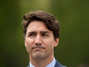 Prime Minister Justin Trudeau stands after speaking to media at the Delta Lodge at Kananaskis west of Calgary, Alta., on Tuesday, April 26, 2016. The federal Liberal cabinet was wrapping up three days of meetings at the lodge. Lyle Aspinall/Postmedia Network