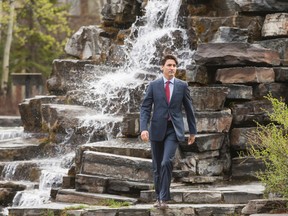 Prime Minister Justin Trudeau walks past a man-made waterfall to his morning meeting at the Delta Lodge at Kananaskis west of Calgary, Alta., on Tuesday, April 26, 2016. The federal Liberal cabinet was wrapping up three days of meetings at the lodge. Lyle Aspinall/Postmedia Network