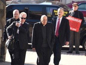 Anthony Criscitelli, far left, and Giles Schinelli, third left, walk towards Blair County Courthouse in Hollidaysburg, Pa., Thursday, April 14, 2016. Records from a Franciscan religious order show three former leaders including Criscitelli and Schinelli knew a friar had been accused of child sex abuse before he was allowed to work at a high school and other jobs where more than 100 people eventually accused him of molesting them as children. Others on the photo are not identified. (J.D. Cavrich/Altoona Mirror via AP)