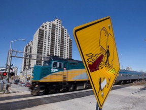 VIA Rail train 73, carrying passengers from Toronto to Windsor, rolls across Ridout Street. (CRAIG GLOVER, The London Free Press)