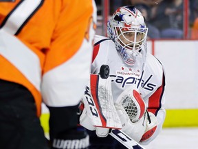 Washington Capitals' Braden Holtby blocks a shot as Philadelphia Flyers' Wayne Simmonds looks for the rebound during the second period of Game 6 in the first round of the NHL playoffs in Philadelphia on April 24, 2016. (AP Photo/Matt Slocum)